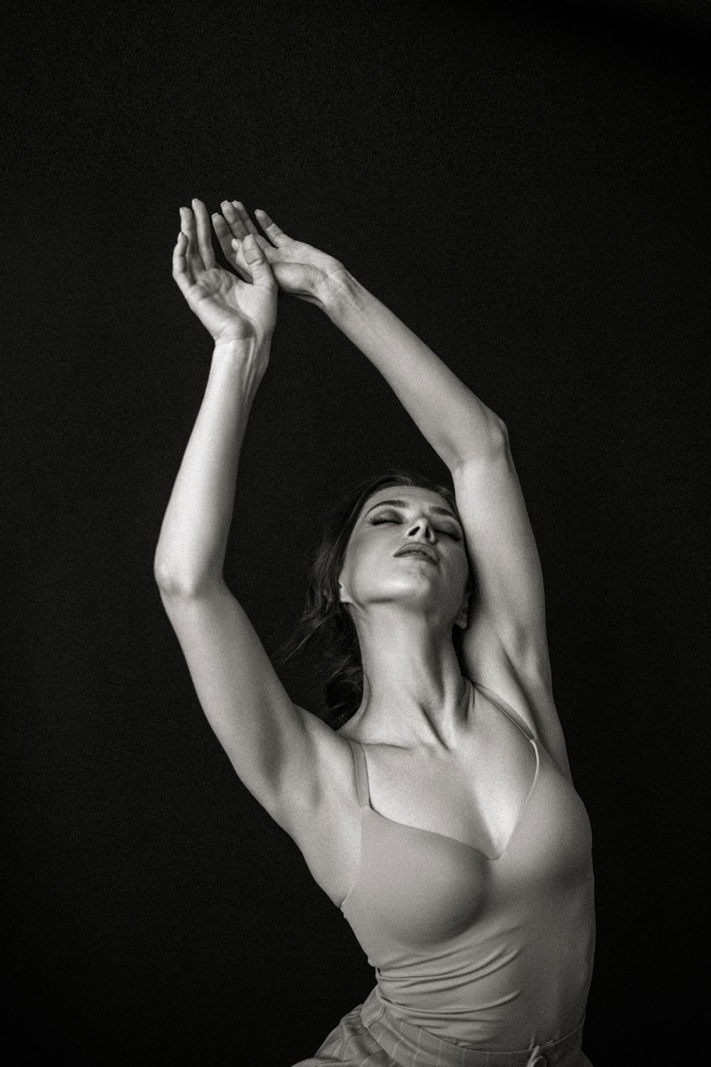 Dancer expressing movement against a dark background.